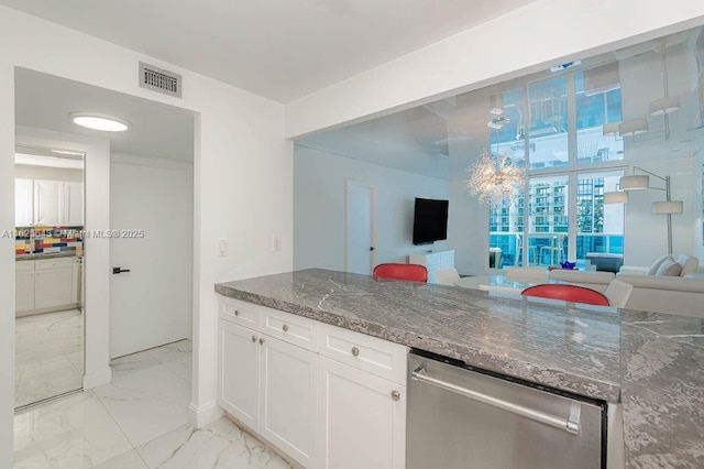 2301 Collins Ave Unit 1204, Miami Beach, FL 33139 - kitchen with stainless steel dishwasher, light marble finish flooring, dark stone countertops, white cabinets, and open floor plan