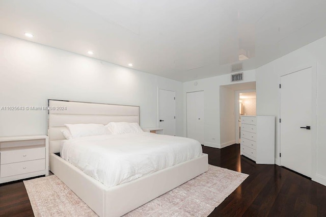 bedroom with dark wood-type flooring