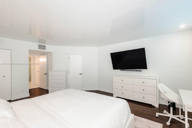 bedroom with dark wood-type flooring