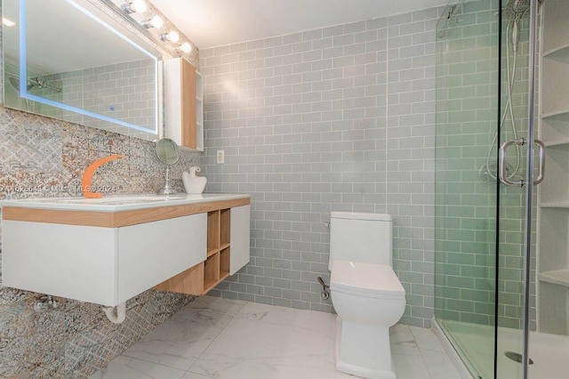 bathroom featuring tasteful backsplash, vanity, tile walls, toilet, and a shower with shower door