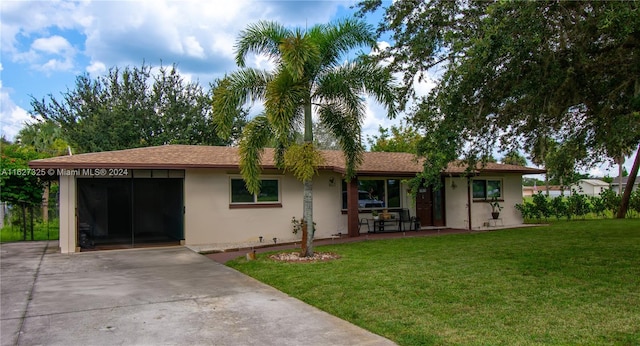 ranch-style home featuring a carport and a front yard