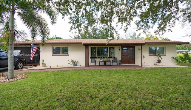 single story home featuring a carport and a front lawn