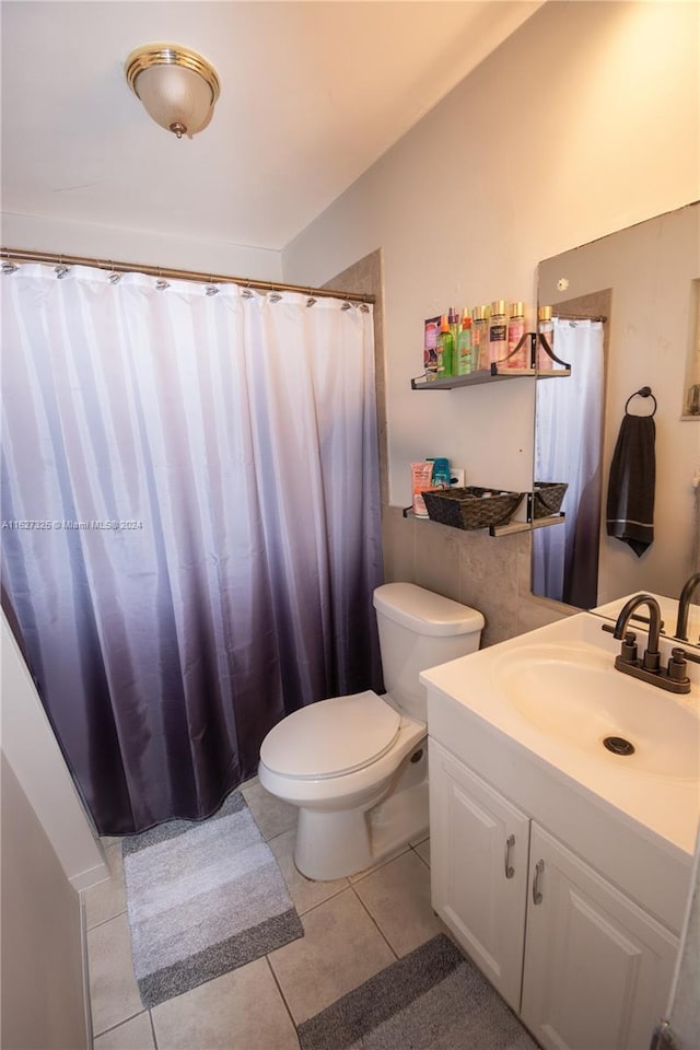 bathroom featuring tile patterned floors, toilet, and vanity