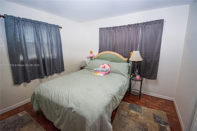 bedroom with dark parquet floors