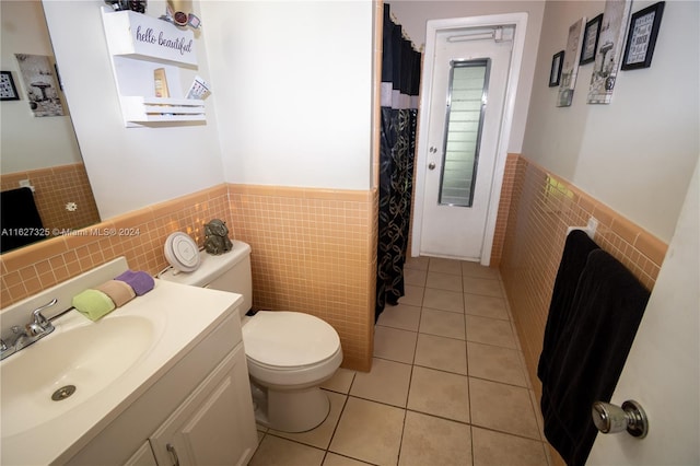 bathroom featuring toilet, tile patterned floors, tasteful backsplash, and tile walls