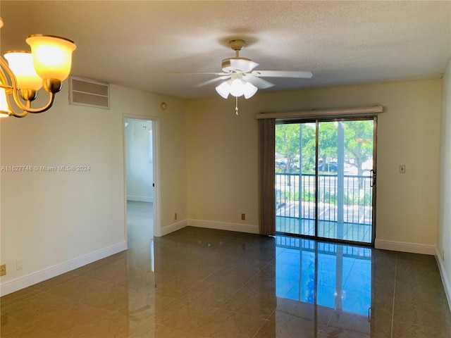 tiled spare room featuring a textured ceiling and ceiling fan