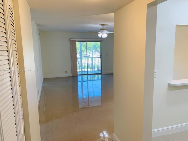 hall featuring light tile patterned floors