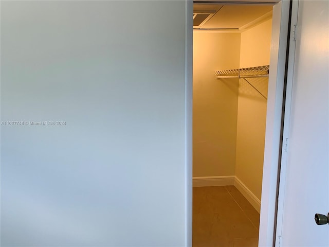 spacious closet with tile patterned floors