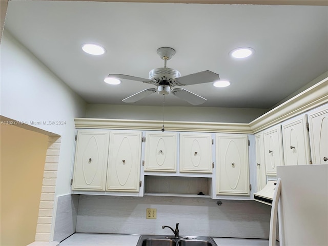 kitchen featuring white cabinets, white refrigerator, sink, light wood-type flooring, and ceiling fan