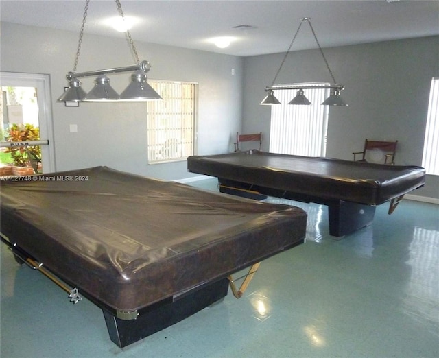 game room with pool table and plenty of natural light