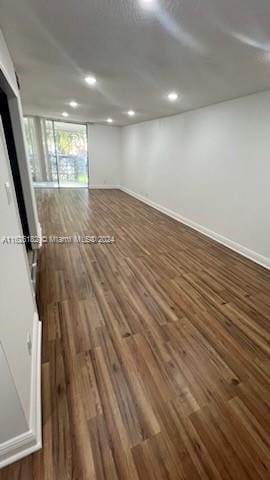 spare room with dark hardwood / wood-style floors