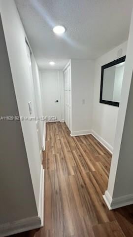 corridor featuring hardwood / wood-style floors