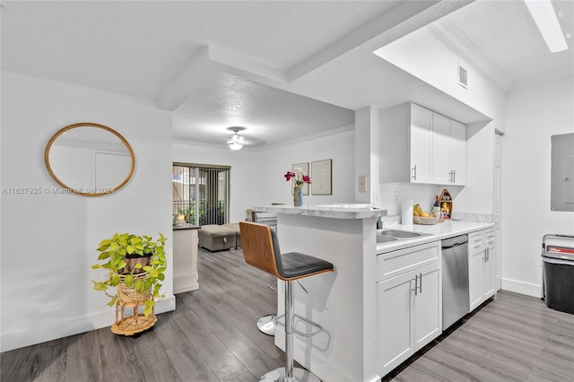 kitchen featuring kitchen peninsula, white cabinetry, stainless steel dishwasher, and light wood-type flooring