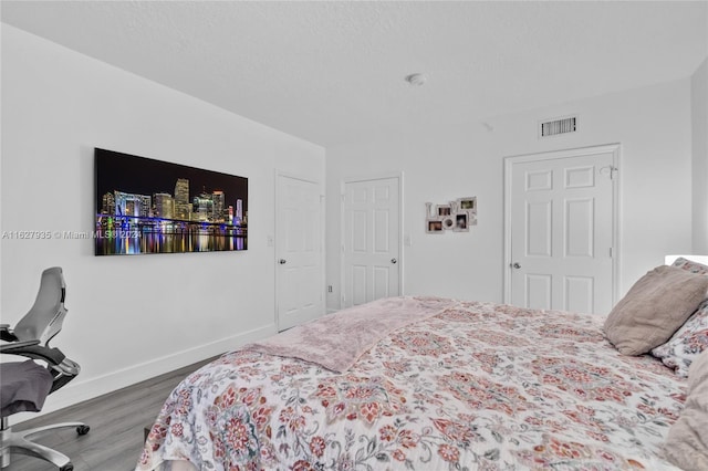 bedroom featuring wood-type flooring