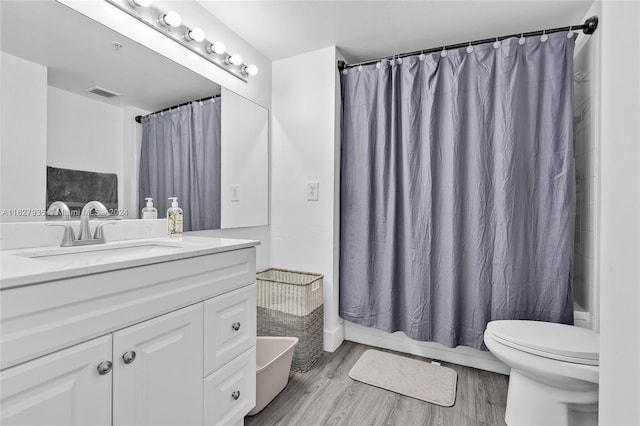 full bathroom with shower / bathtub combination with curtain, toilet, vanity, and wood-type flooring