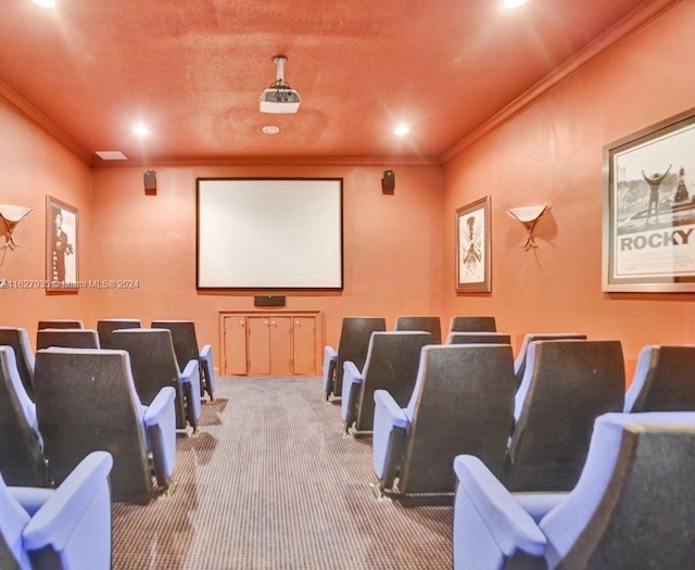 home theater room featuring ornamental molding and carpet flooring