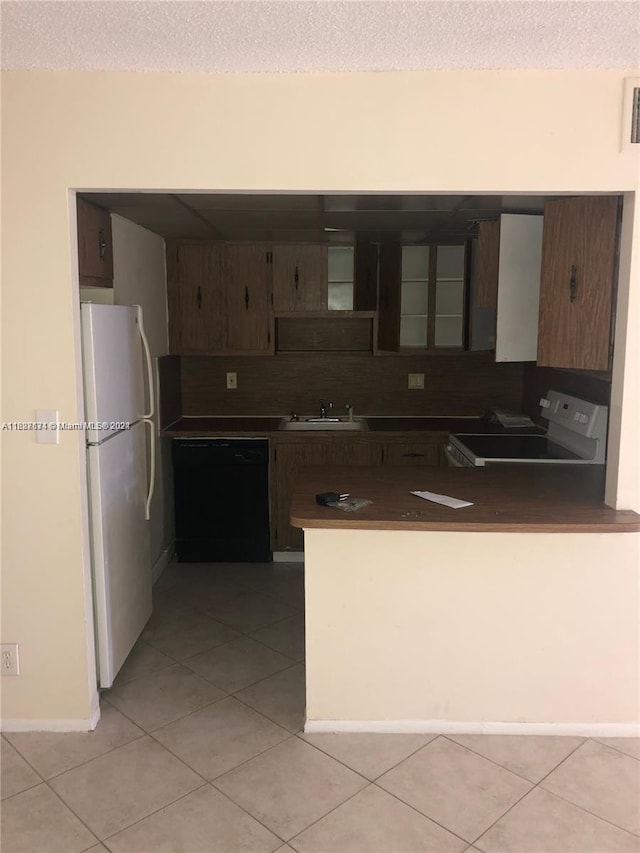 kitchen with stove, sink, backsplash, dishwasher, and white fridge