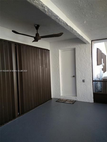 interior space with ceiling fan