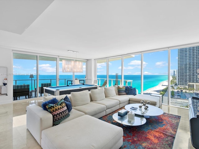 tiled living room with floor to ceiling windows, a wealth of natural light, pool table, and a water view