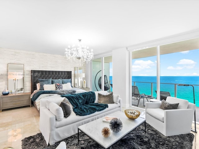 bedroom featuring a water view and a notable chandelier