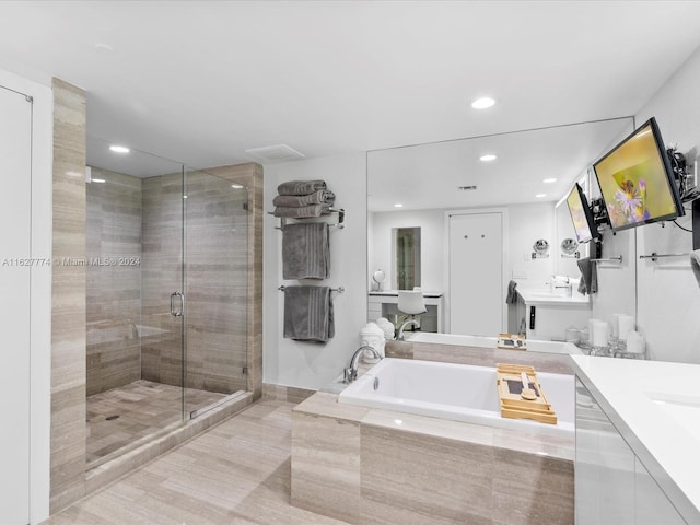 bathroom featuring vanity and plus walk in shower