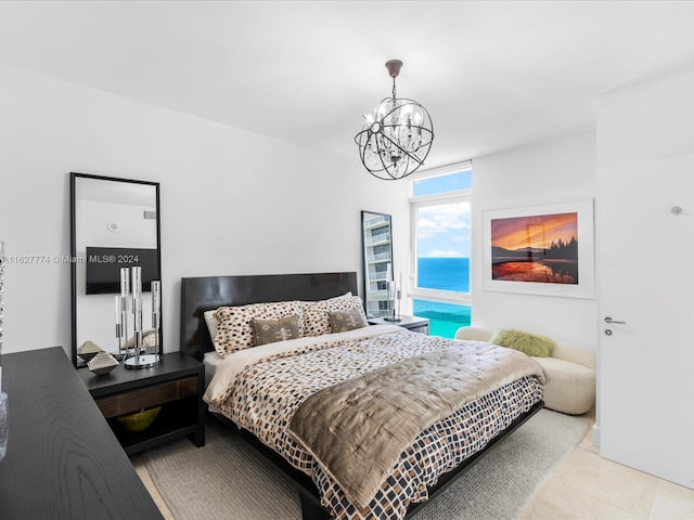 bedroom featuring a chandelier, a water view, and light tile patterned floors