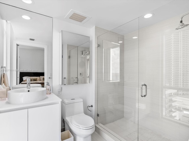 bathroom with toilet, an enclosed shower, and vanity