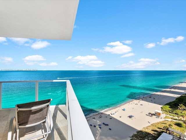 balcony with a water view and a beach view