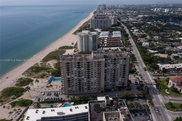 birds eye view of property featuring a water view, a view of the beach, and a city view