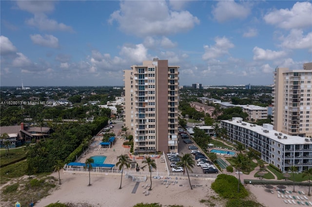 view of property featuring uncovered parking and a city view