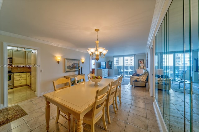 dining area featuring baseboards, ornamental molding, a chandelier, and light tile patterned flooring