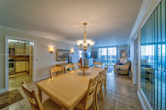 dining space with a notable chandelier, light tile patterned floors, baseboards, and crown molding