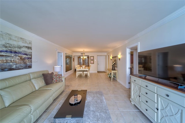 living area featuring a chandelier, ornamental molding, light tile patterned floors, and baseboards