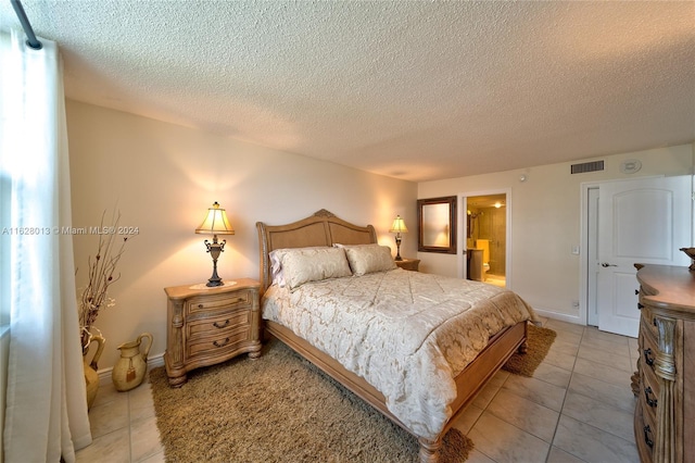 bedroom with visible vents, baseboards, and light tile patterned flooring