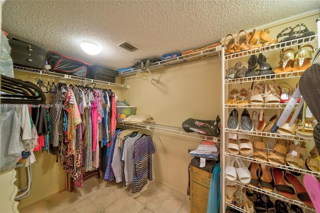 walk in closet featuring tile patterned flooring and visible vents