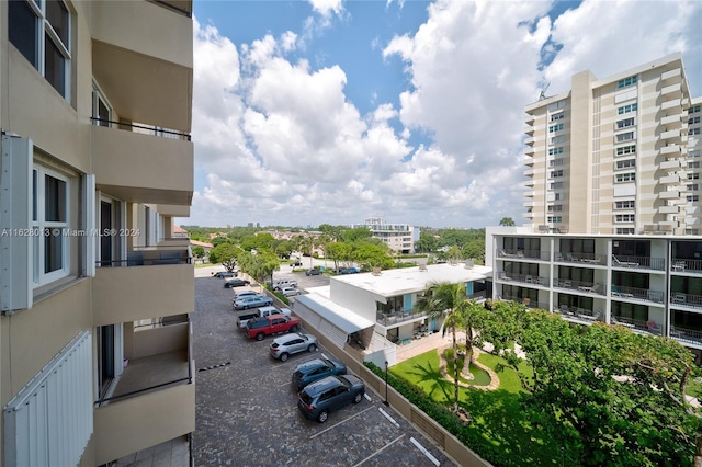 exterior space featuring uncovered parking and a city view