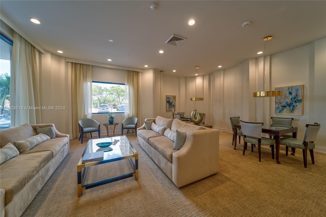 carpeted living area with baseboards, visible vents, and recessed lighting