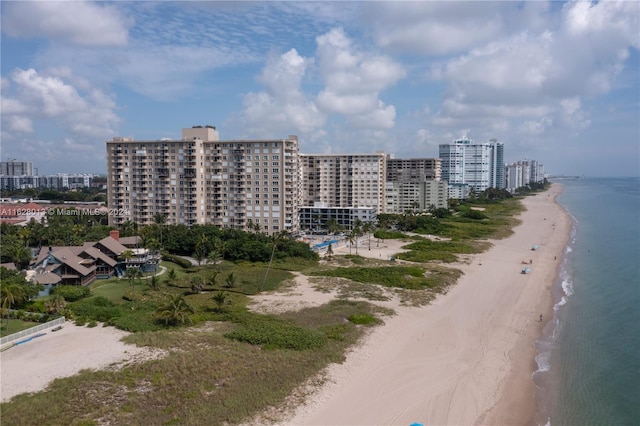 bird's eye view with a city view, a water view, and a beach view