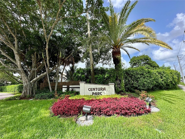 community sign featuring a lawn