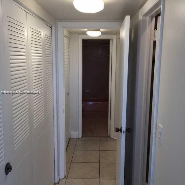 hallway featuring light tile patterned floors