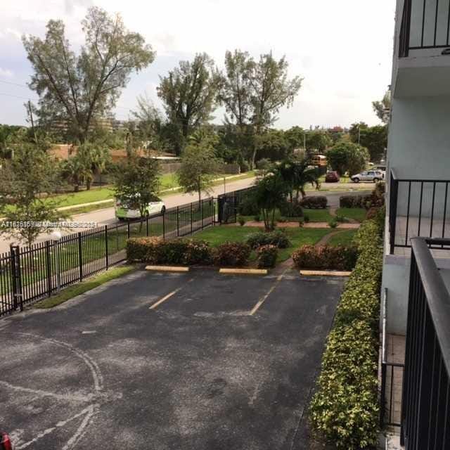 12500 NE 15th Ave Unit 207, North Miami, FL 33161 - uncovered parking lot featuring fence