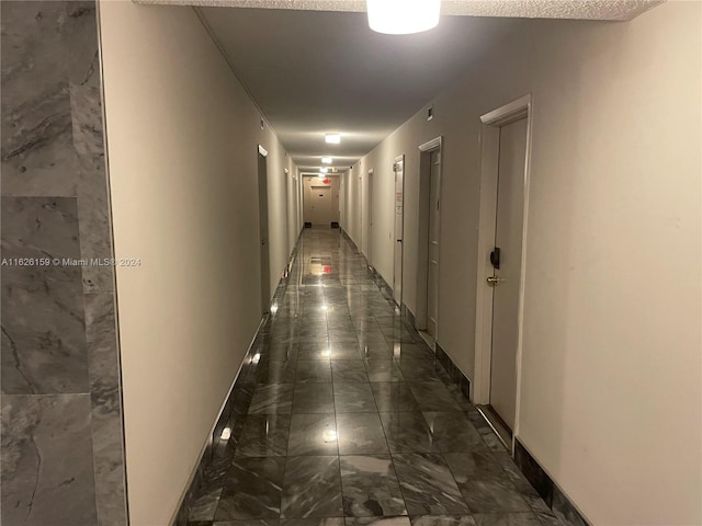 corridor featuring dark tile patterned flooring