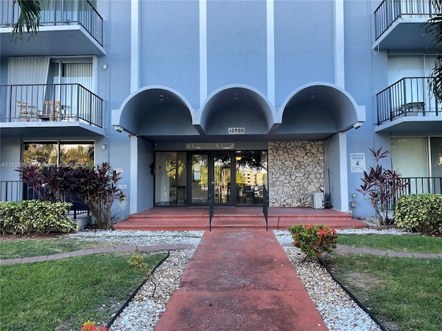 12500 NE 15th Ave Unit 207, North Miami, FL 33161 - entrance to property with stone siding, stucco siding, and cooling unit