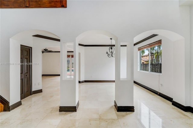 tiled empty room featuring ceiling fan