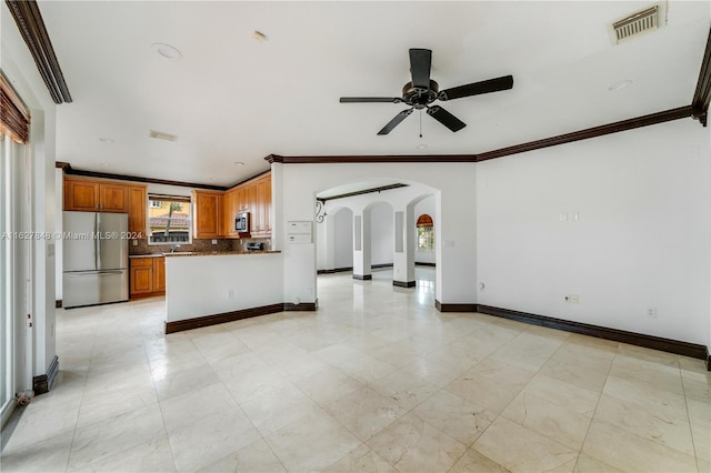 kitchen with light tile patterned floors, ornamental molding, appliances with stainless steel finishes, tasteful backsplash, and ceiling fan