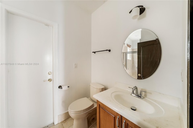 bathroom featuring tile patterned floors, vanity, and toilet