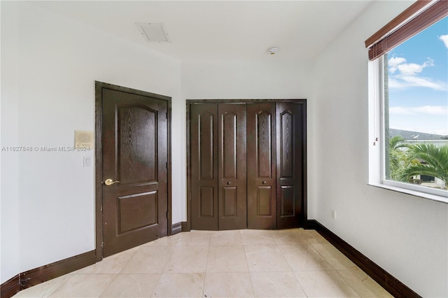 tiled bedroom with a closet