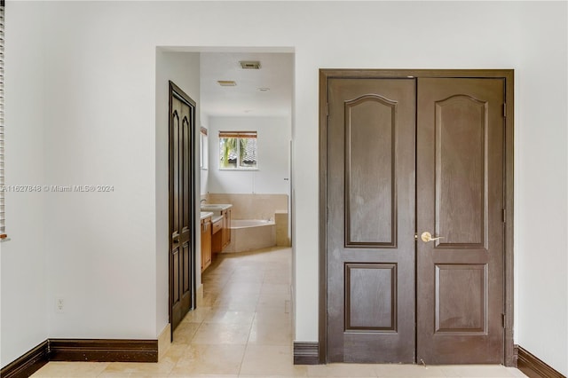 hallway with light tile patterned floors