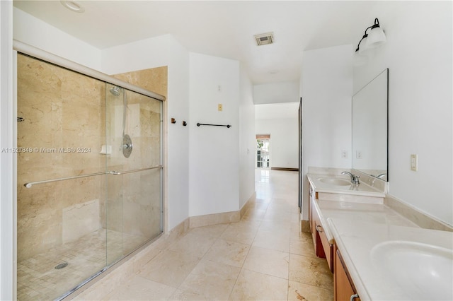 bathroom featuring dual vanity, walk in shower, and tile patterned floors