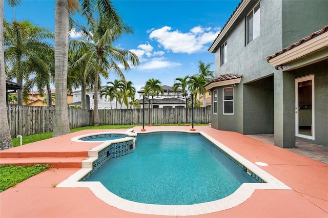 view of swimming pool with a patio area and an in ground hot tub